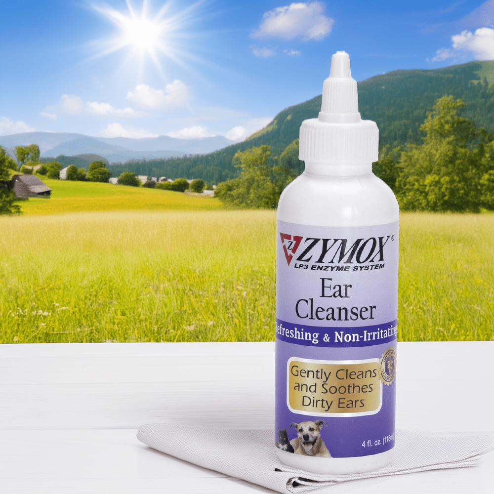 Zymox Ear Cleanser – Enzyme-Based Solution for Gentle Dog Ear Cleaning A bottle of Zymox Ear Cleanser placed on a white cloth against a scenic countryside background. This enzyme-based ear cleaner gently cleans and soothes dirty ears, making it an excellent choice for routine dog ear cleaning and ear health maintenance.
